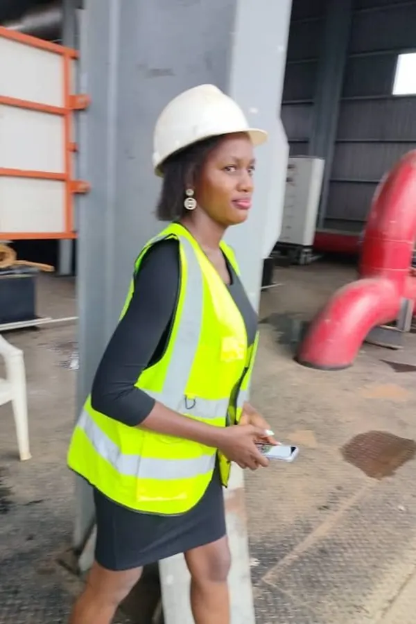 EHS clinician in a hard hat and safety vest during a workplace site visit